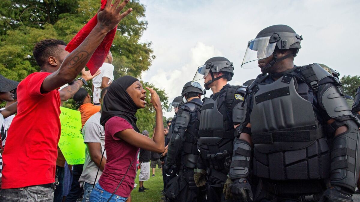 Protesters and police face off in front of Baton Rouge Police Department headquarters on July 9, 2016.