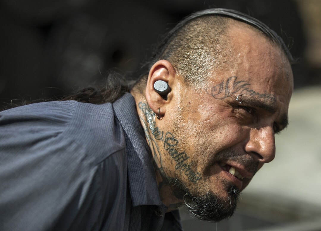 Thomas Urioste, 50, an employee at U.S. Rubber Recycling, breaks into a sweat while working outside in the sun.