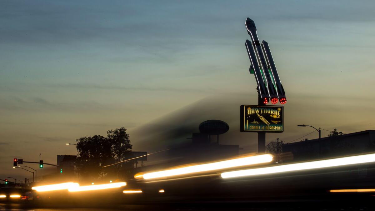 A 37-foot-tall model of SpaceX's Falcon Heavy rocket sits above a median in Hawthorne, Calif.