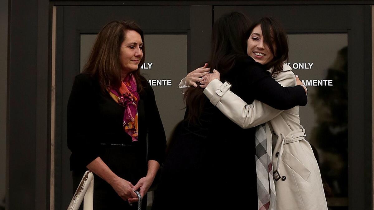 Michelle Hadley, center, gets a hug as she emerges from a Fullerton court where she was exonerated.