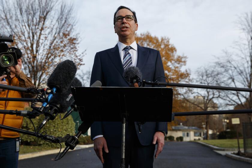 FILE - In this Dec. 3, 2018, file photo, Treasury Secretary Steve Mnuchin talks with reporters at the White House in Washington. Trump says he has confidence in Mnuchin, calling him a "very talented guy" and a "very smart person." (AP Photo/Evan Vucci, File)