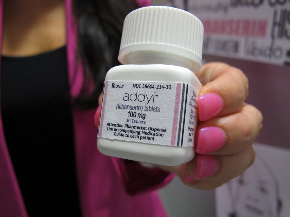 Sprout Pharmaceuticals Chief Executive Cindy Eckert holds a bottle of the female sex-drive drug Addyi.