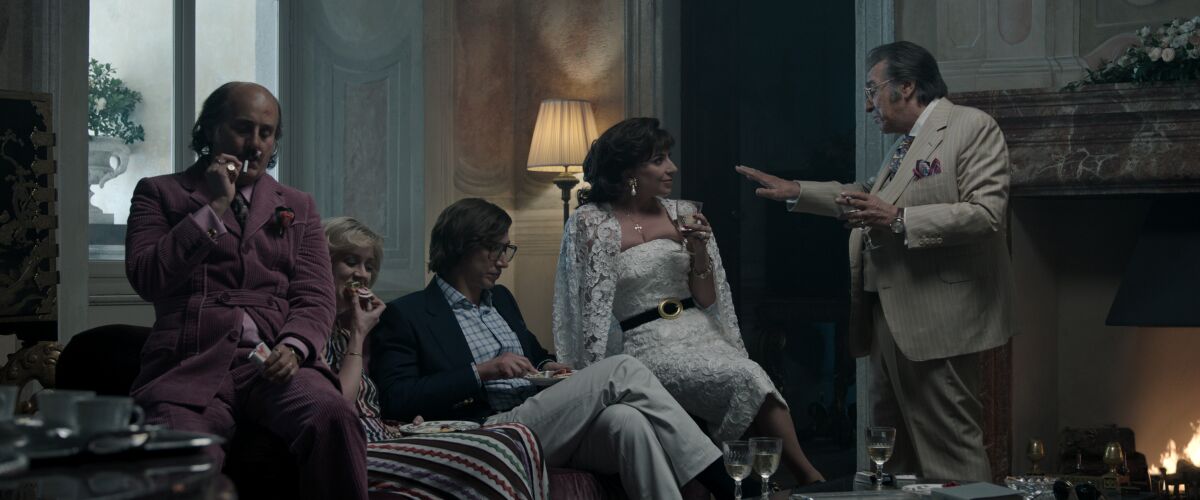 A scene from "House of Gucci" showing Jared Leto, Florence Andrews, Adam Driver, Lady Gaga and Al Pacino talking together.