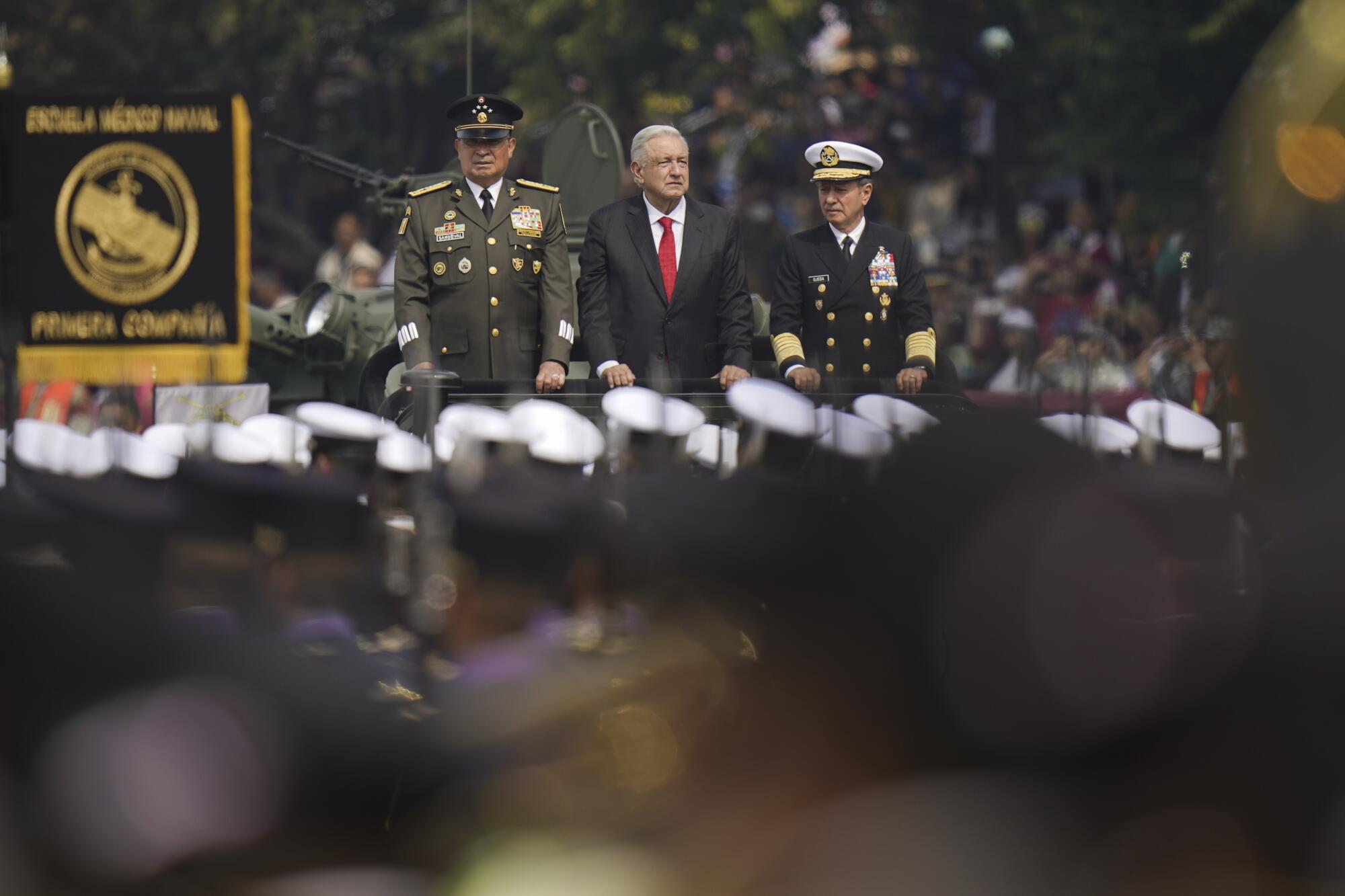 Andrés Manuel López Obrador rides in a vehicle with two uniformed men