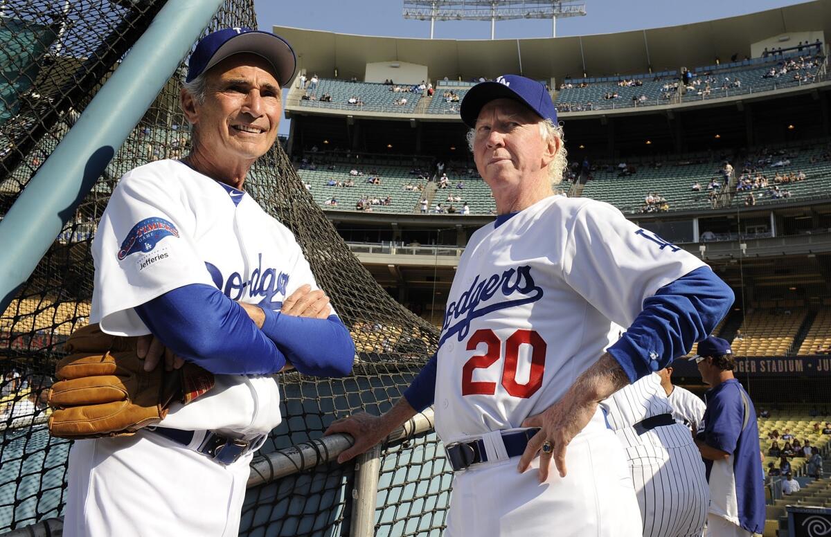 Dodgers pitching greats Don Sutton, right, and Sandy Koufax talk before an old-timers game at Dodger Stadium in June 2013. 
