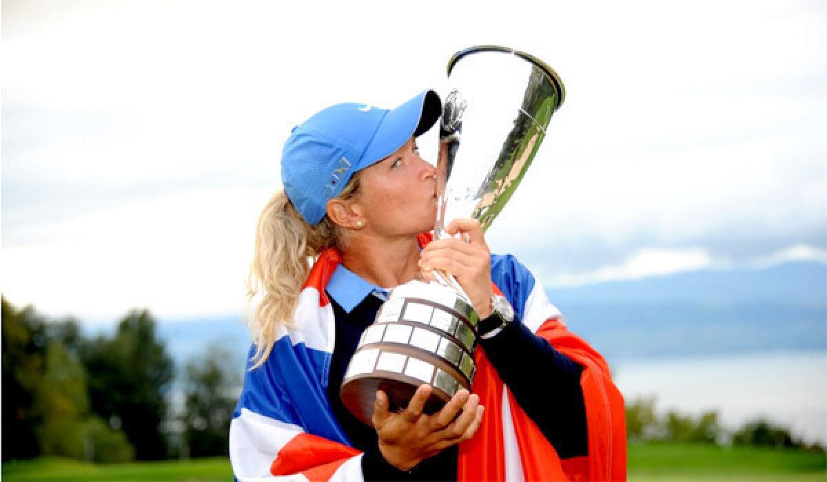 Golfer Suzann Pettersen kisses her trophy after winning the Evian Championship after shooting a three-under-par 68 at the Evian Resort Golf Club on Sunday.