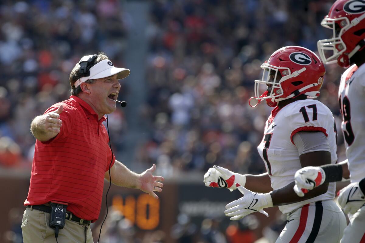 Georgia head coach Kirby Smart celebrates after a defensive stop during the first half of an NCAA college football game against Auburn, Saturday, Oct. 9, 2021, in Auburn, Ala. (AP Photo/Butch Dill)