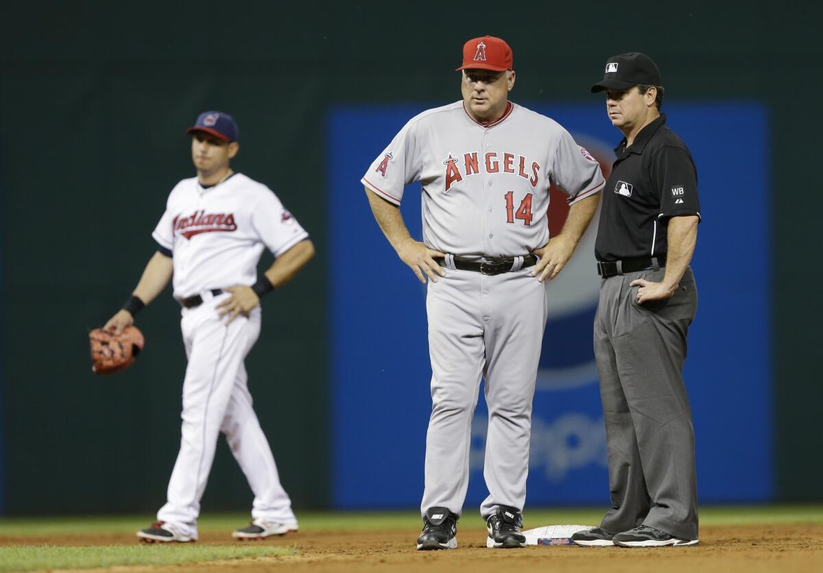 Angels Manager Mike Scioscia stands with second base umpire Rob Drake while deciding whether or not to challenge the ruling that Raul Ibanez was caught stealing by Cleveland in the eighth inning. Scioscia didn't challenege, the Angels lost 4-3.