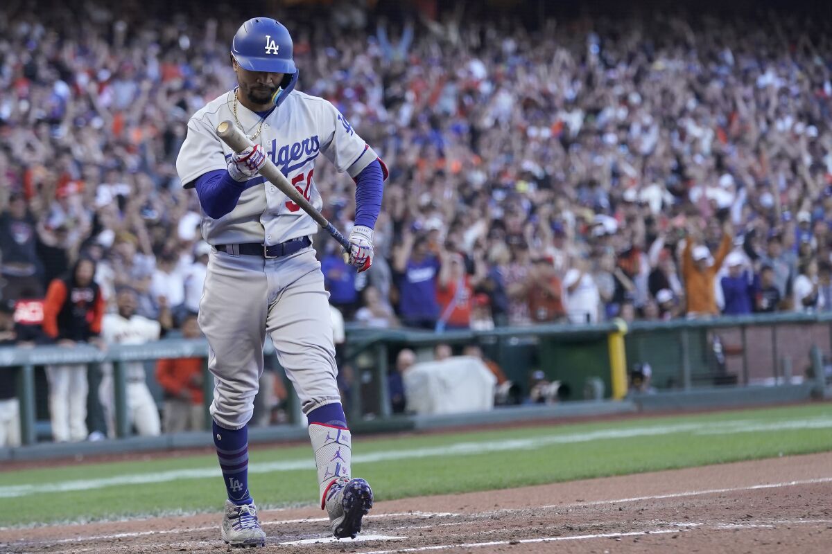 The Dodgers' Mookie Betts walks to the dugout after striking out against the Giants during the eighth inning June 11, 2022.