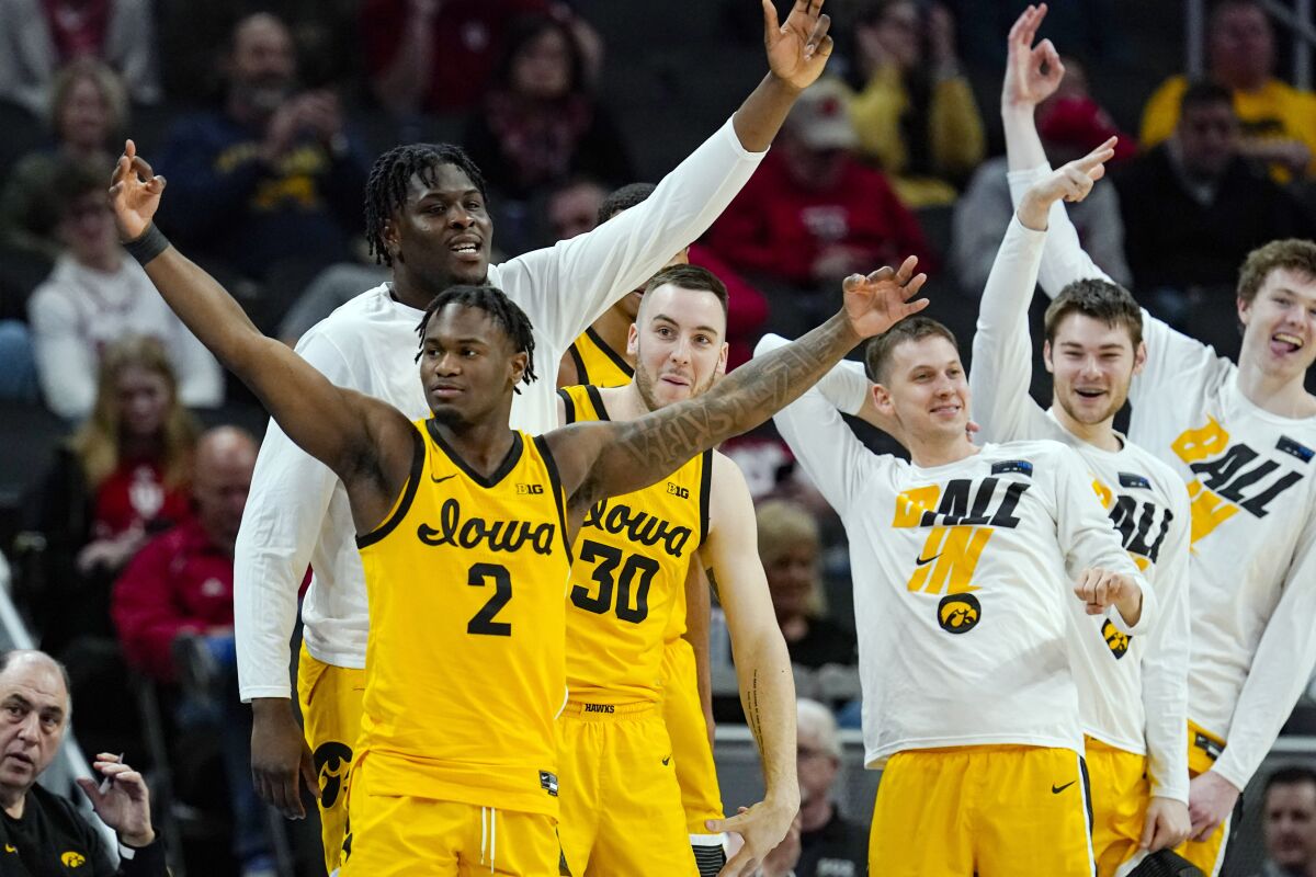 Iowa guard Joe Toussaint (2) and the Iowa bench celebrate in the first half of an NCAA college basketball game against Northwestern at the Big Ten Conference tournament in Indianapolis, Thursday, March 10, 2022. (AP Photo/Michael Conroy)