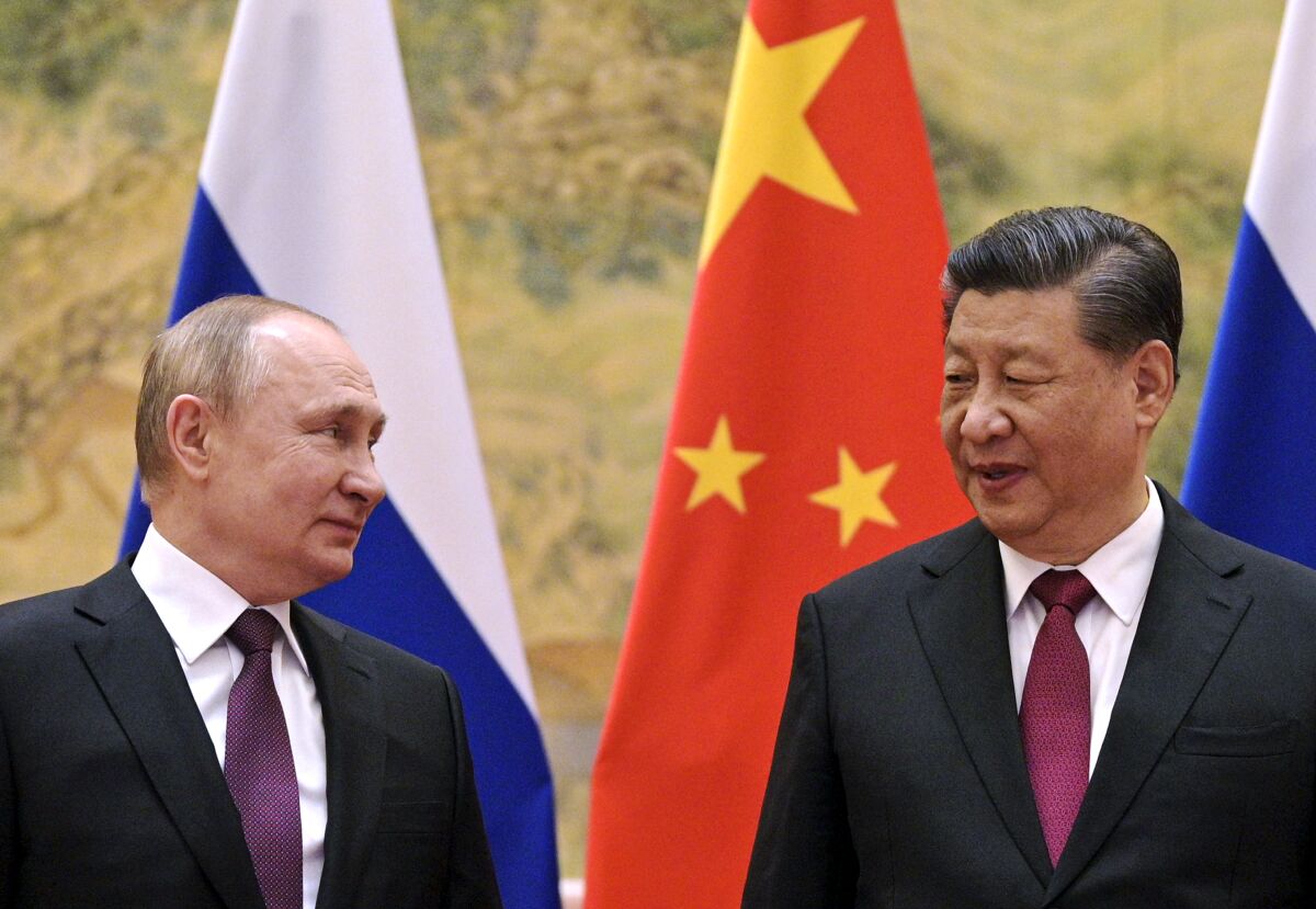 FILE - Chinese President Xi Jinping, right, and Russian President Vladimir Putin looks towards each other during their meeting in Beijing, China, on Feb. 4, 2022. China has described reports and images of civilian killings in Ukraine as disturbing, and urged that they be further investigated, even while declining to blame Russia. That's drawn questions about the resiliency of Beijing's support for Moscow, but speculation that it is weakening appears to be misplaced. (Alexei Druzhinin, Sputnik, Kremlin Pool Photo via AP, File)
