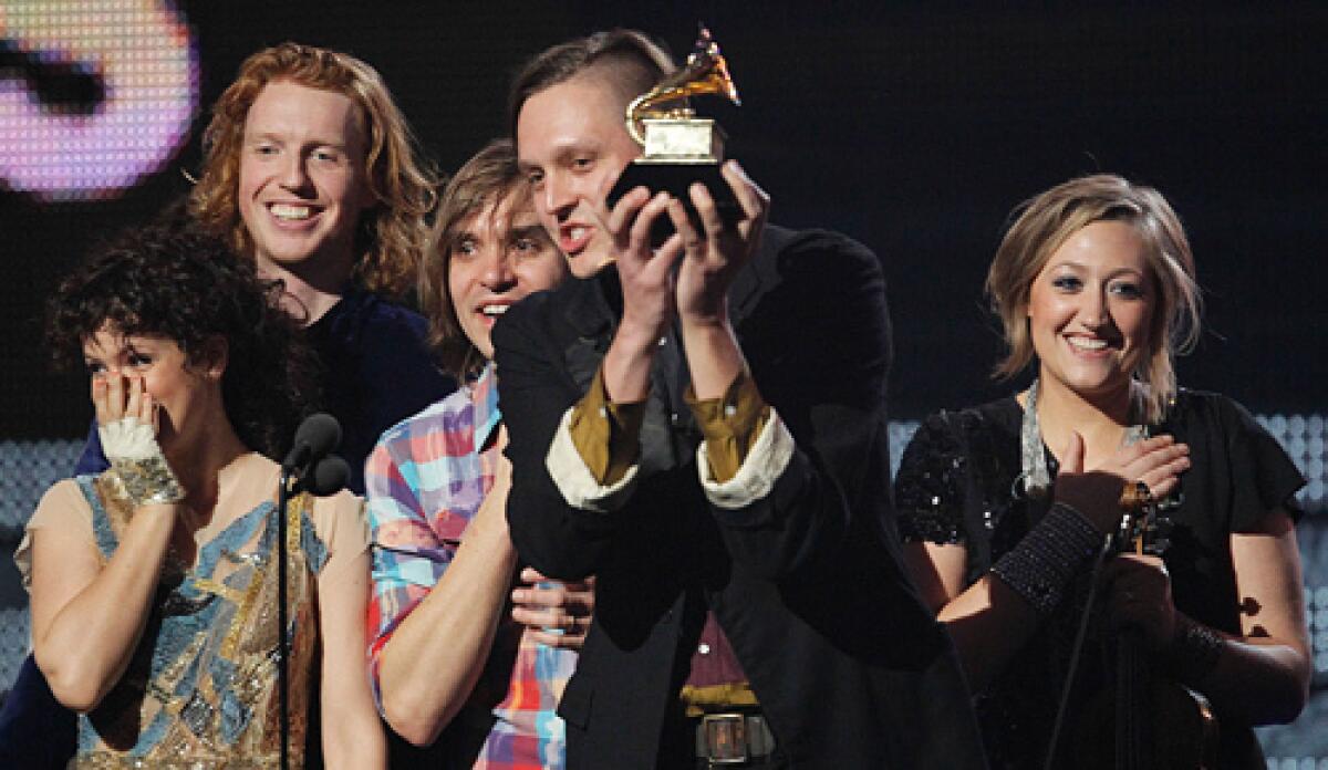 The Canadian indie band Arcade Fire's exuberant "The Suburbs" CD was named album of the year in the evening's biggest upset.