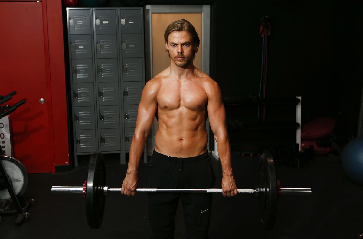 Derek Hough, dancer, choreographer, singer and entertainer, does an exercise to strengthen his back and core muscles at Pulse Fitness Studio in Sherman Oaks on July 29.