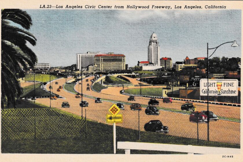 A historic postcard showing the Hollywood Freeway and downtown Los Angeles.
