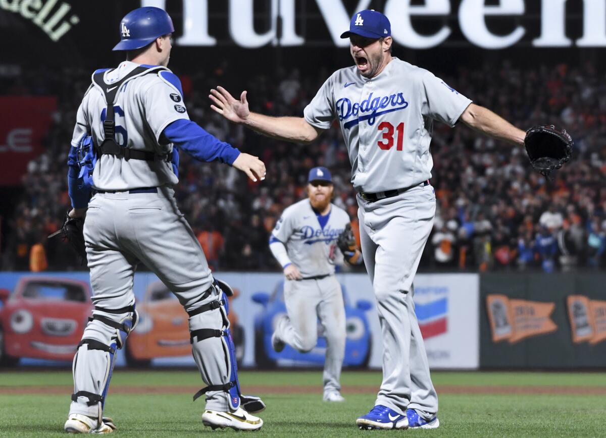 Dodgers pitcher Max Scherzer celebrates with catcher Will Smith after the final out.