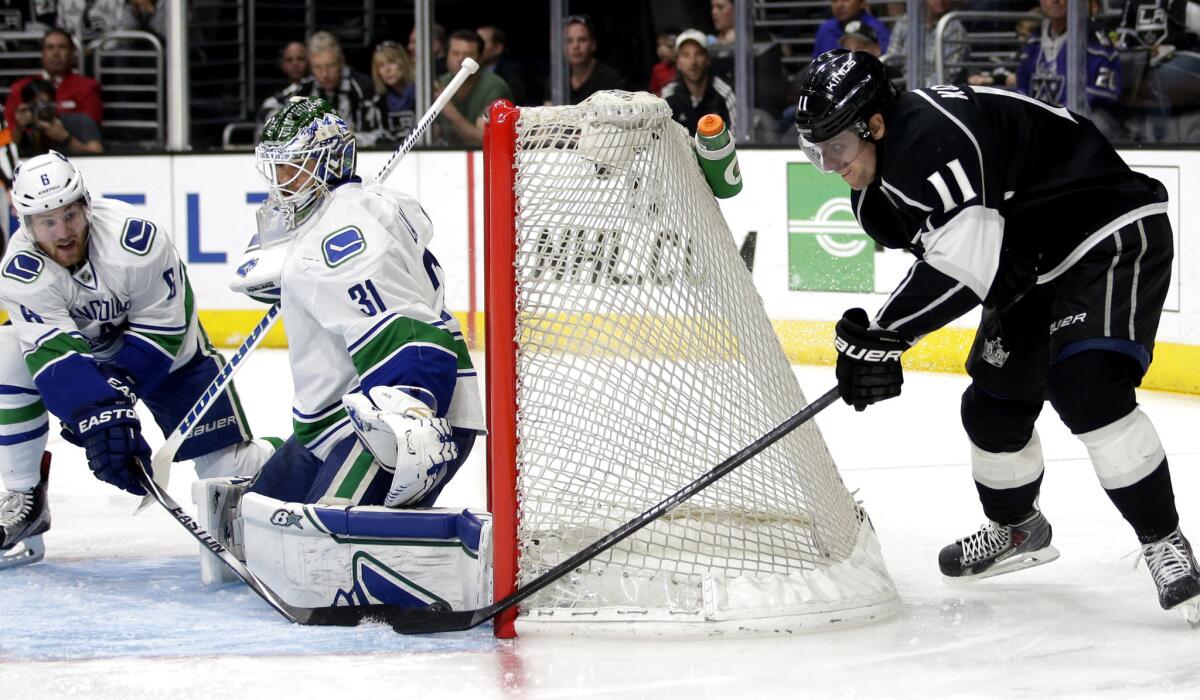 Kings center Anze Kopitar (11) tries to score on a wrap-around shot against Canucks goalie Eddie Lack in the second period.