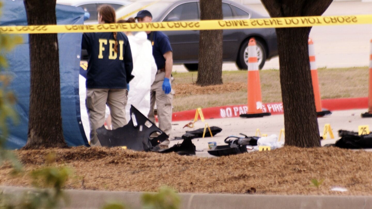 An FBI agent views the area where a car linked to a shooting incident in Garland, Texas, was blown up by police as a precaution on May 4.