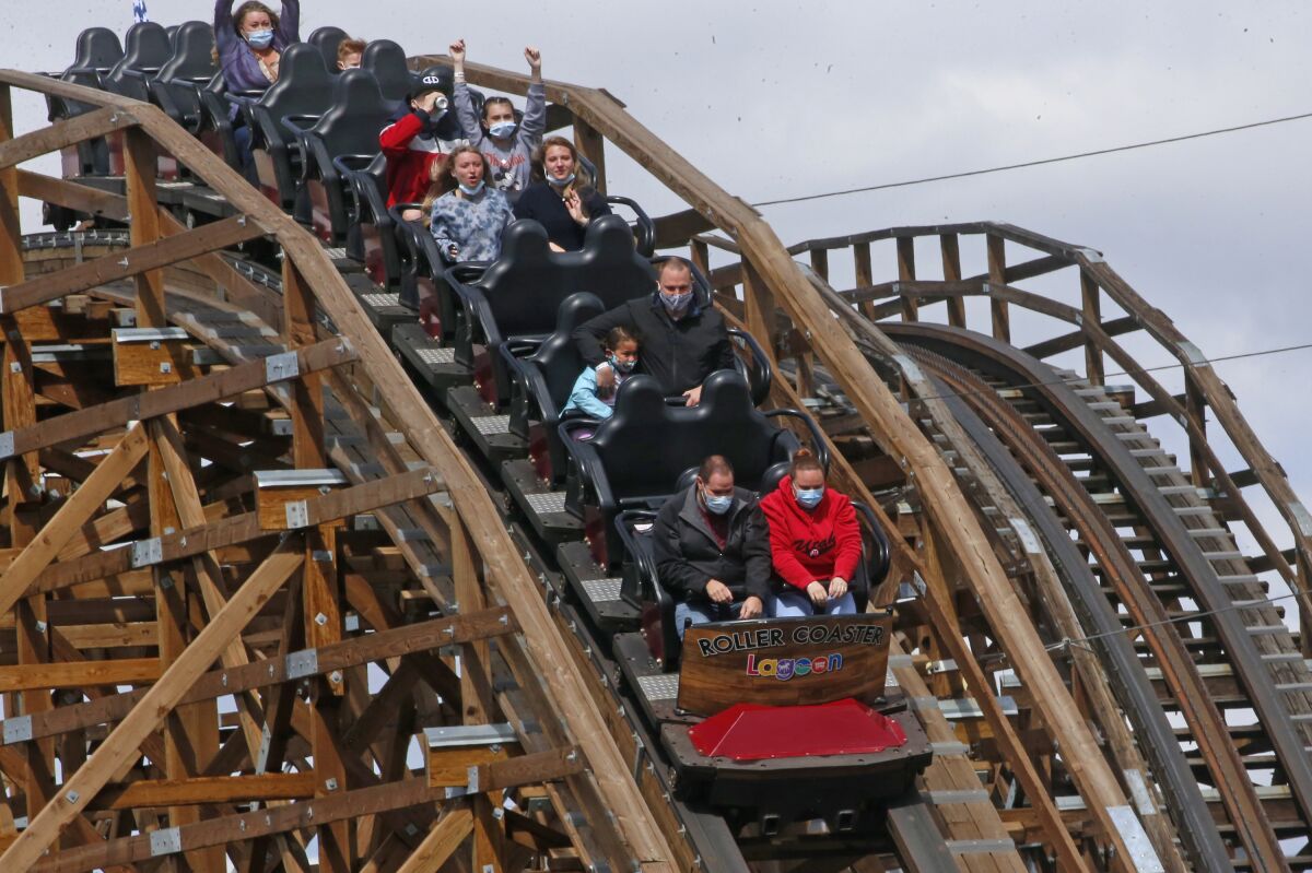 FILE - In this May 23, 2020, file photo, visitors ride the roller coaster at Lagoon Amusement Park in Farmington, Utah. A paraplegic man, not pictured, who was injured on a roller coaster at the park is now suing, saying his paralyzed leg wasn't properly secured while he was on the ride and his foot was shredded. The Salt Lake Tribune reports Matthew Christensen filed the lawsuit against Lagoon Amusement Park on Thursday, Sept. 2, 2021, in Davis County's 3rd District Court. (AP Photo/Rick Bowmer, File)