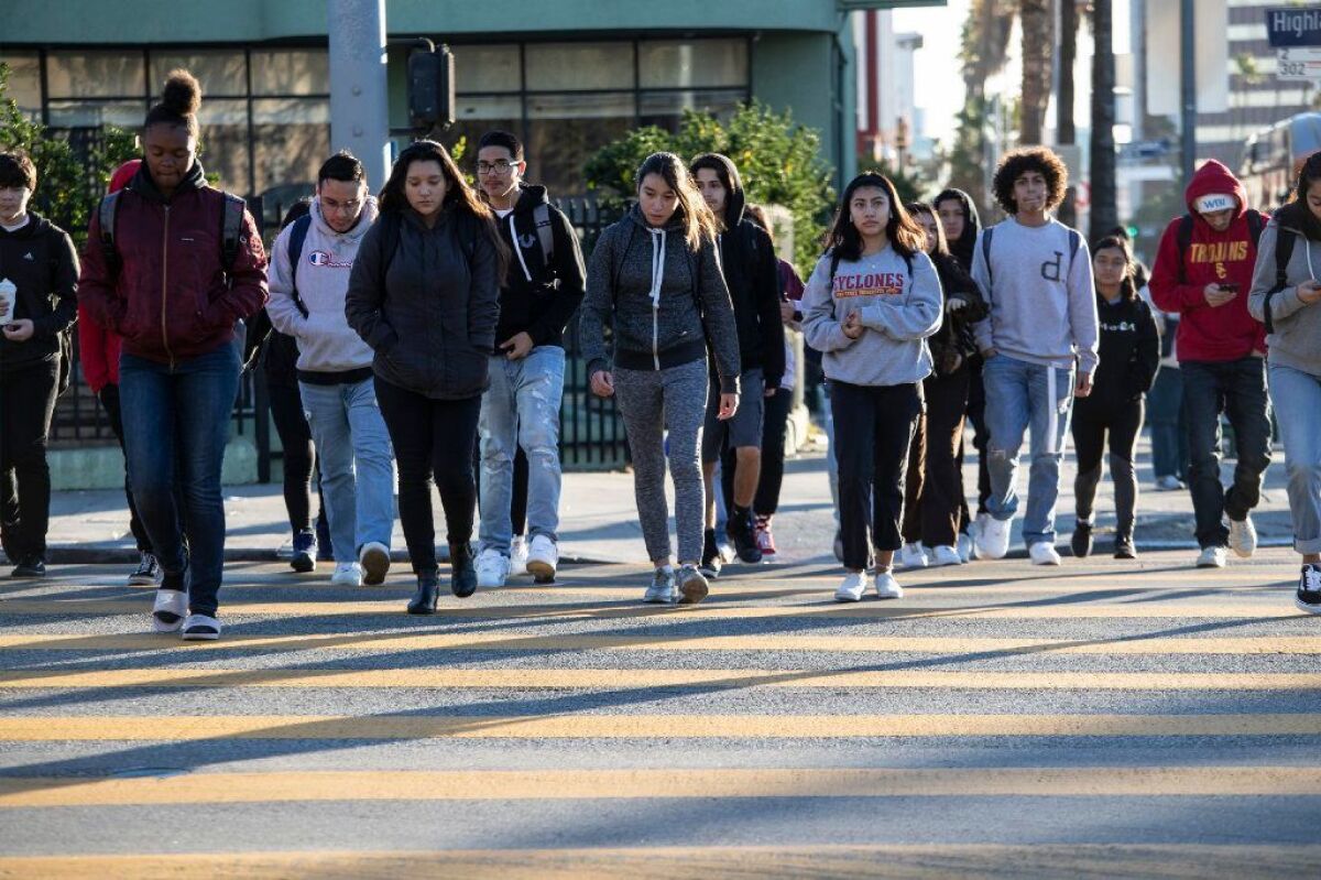 Students cross Highland Avenue to the Hollywood High campus after the Los Angeles teachers' strike.