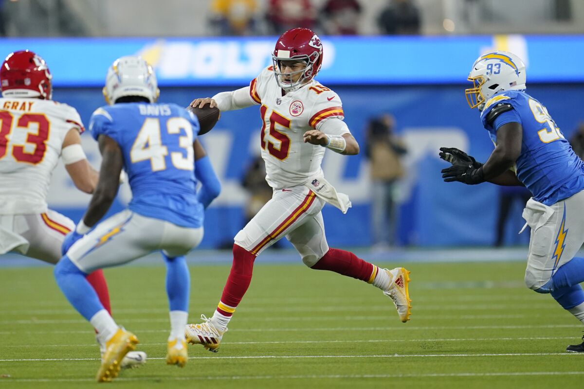 Chiefs quarterback Patrick Mahomes runs to the first down against the Chargers at SoFi Stadium.