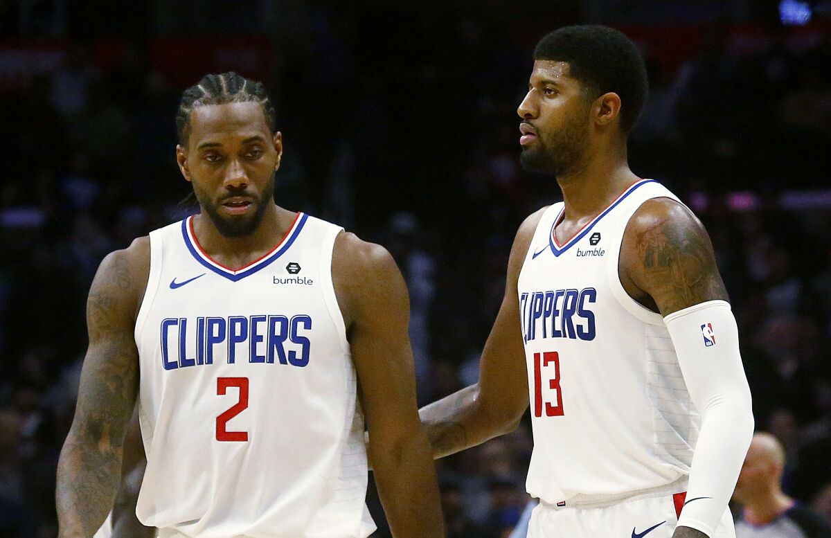 Clippers stars Kawhi Leonard and Paul George take the court together during the fourth quarter of a game Nov. 20 against the Celtics at Staples Center.