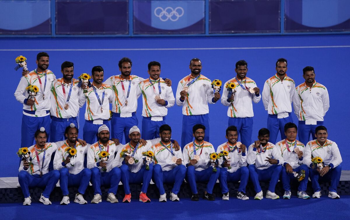 FILE - The India field hockey team poses for a photo with their bronze medal after taking third place in the men's field hockey event at the 2020 Summer Olympics, on Aug. 5, 2021, in Tokyo, Japan. As Olympic sports target new and more dynamic youth-focused formats, field hockey is making its move toward a first World Cup for a five-a-side version and one day joining the Summer Games.(AP Photo/John Locher, File)