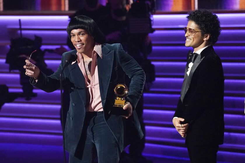 Anderson .Paak, left, and Bruno Mars of Silk Sonic accept the award for record of the year for "Leave the Door Open" at the 64th Annual Grammy Awards on Sunday, April 3, 2022, in Las Vegas. (AP Photo/Chris Pizzello)