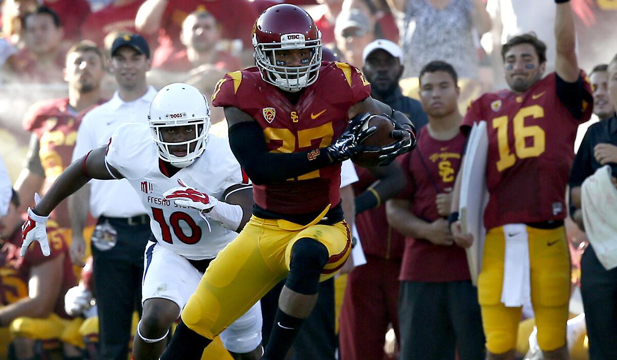 USC safety Gerald Bowman steps in front of Fresno State receiver Greg Watson for an interception during the season opener at the Coliseum on Aug. 30.