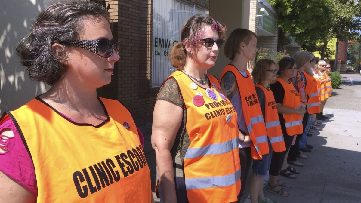 Volunteer clinic escorts line up outside the EMW Women's Surgical Center in Louisville, Kentucky's only licensed abortion clinic, in 2017.