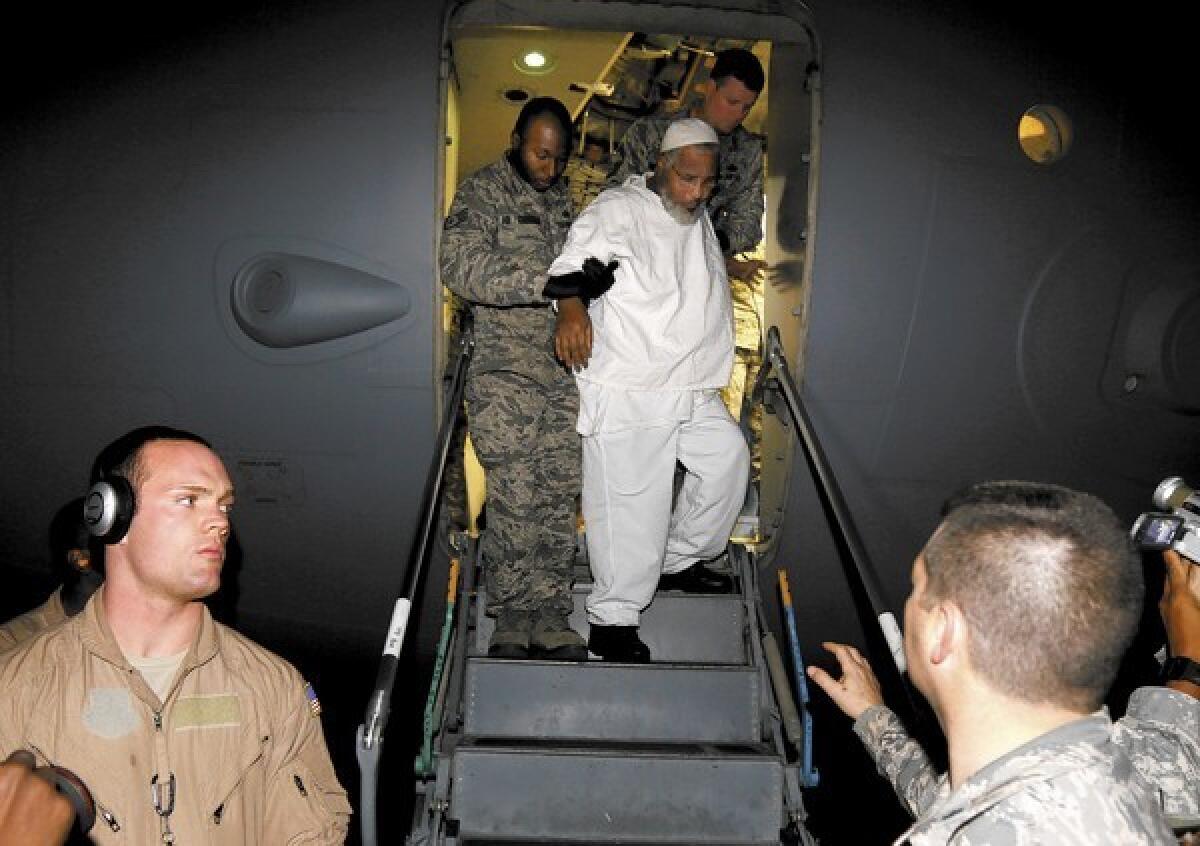 Ibrahim Othman Ibrahim Idris is escorted Thursday off a U.S. military plane in Khartoum, Sudan, after his release from the U.S. military prison at Guantanamo Bay, Cuba.