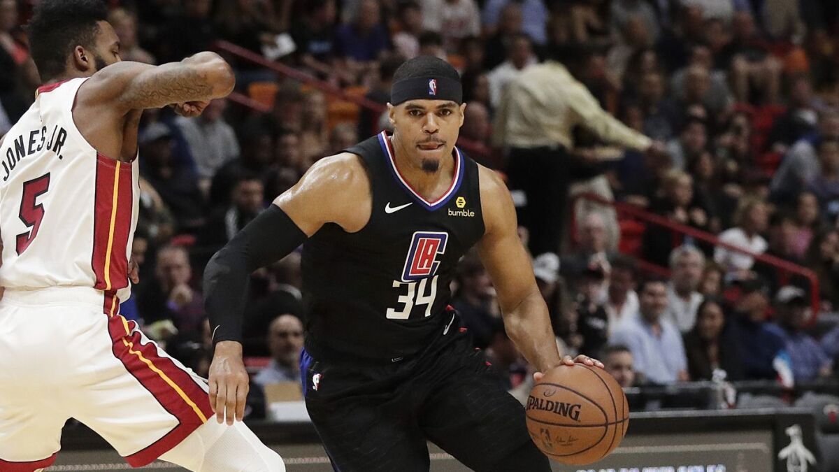 Clippers forward Tobias Harris drives against Heat forward Derrick Jones Jr. Wednesday in Miami.