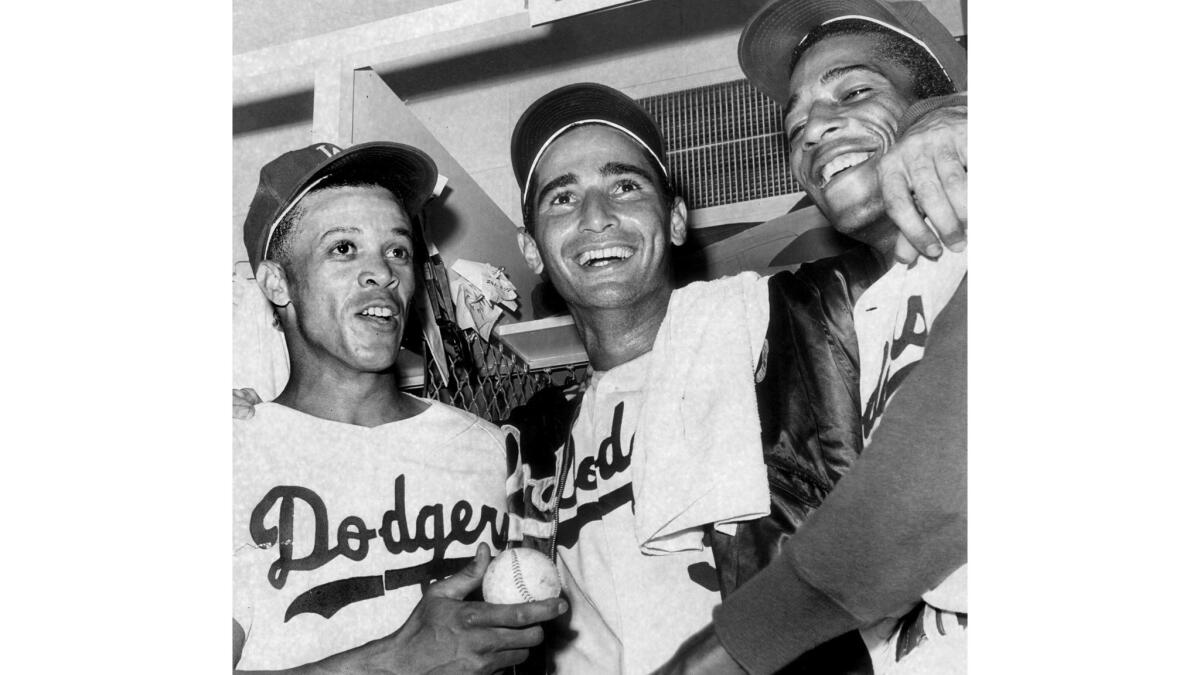 October 11, 1965: Dodgers, from left, Maury Wills, Sandy Koufax and Willie Davis celebrate after winning Game 5 of the 1965 World Series against the Minnesota Twins.