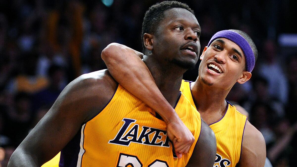 Lakers forward Julius Randle is hugged by Jordan Clarkson after making the go-ahead basket against the Miami Heat late in a 102-100 victory on March 30.
