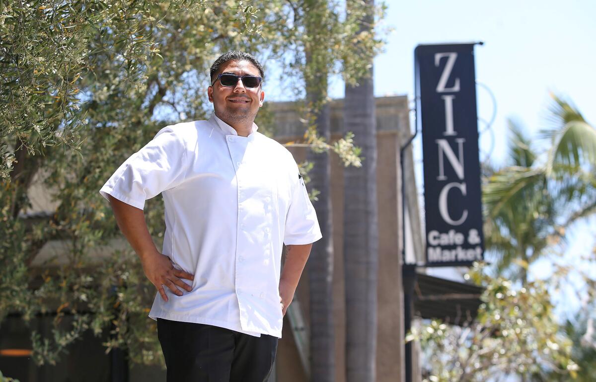 Martin Hernandez stands in front of the Zinc Cafe in Corona del Mar. He and wife, Alix Wiesen-Todd, who also works in the restaurant industry, contracted the coronavirus in March and were in recovery when they decided to use their culinary talents to help families in need.