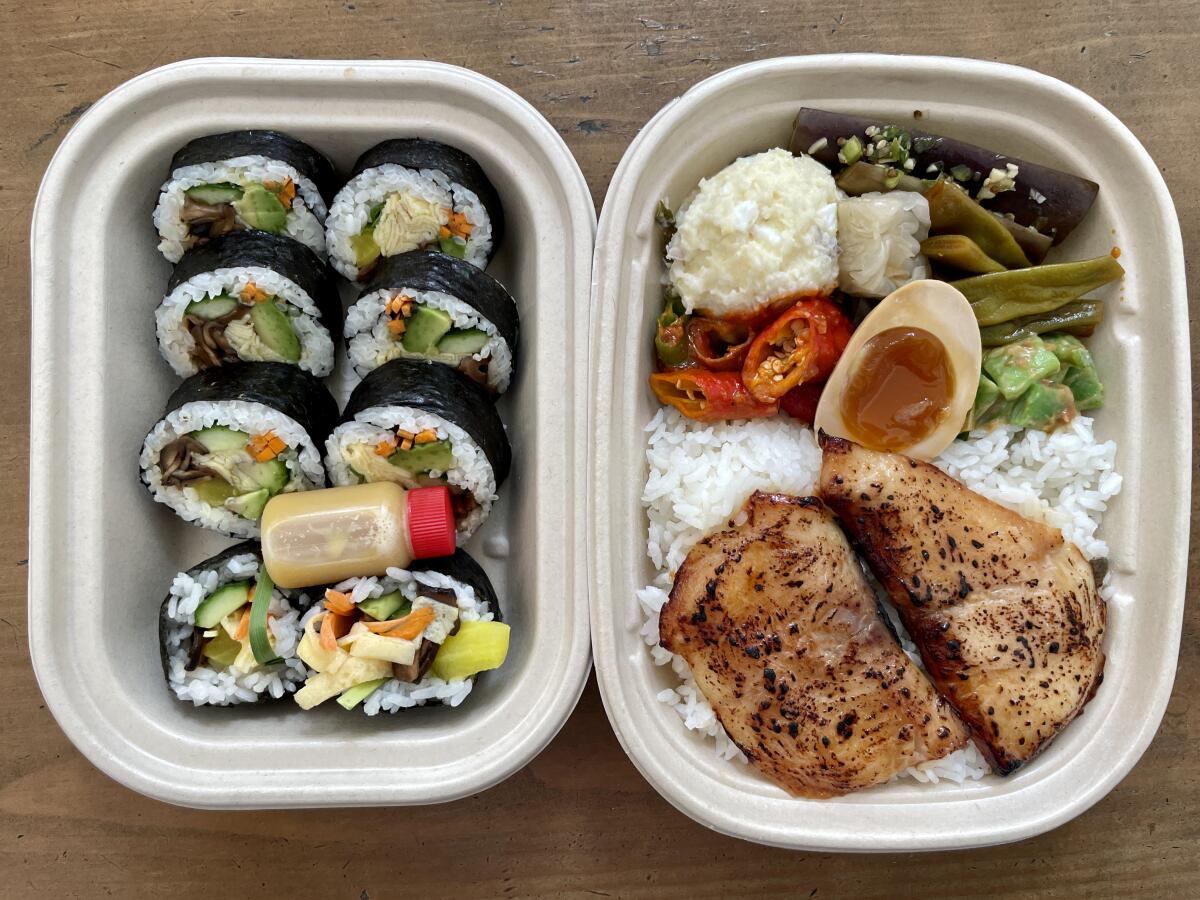 Takeout containers of gimbap, left, and a fish dosirak from Perilla. 