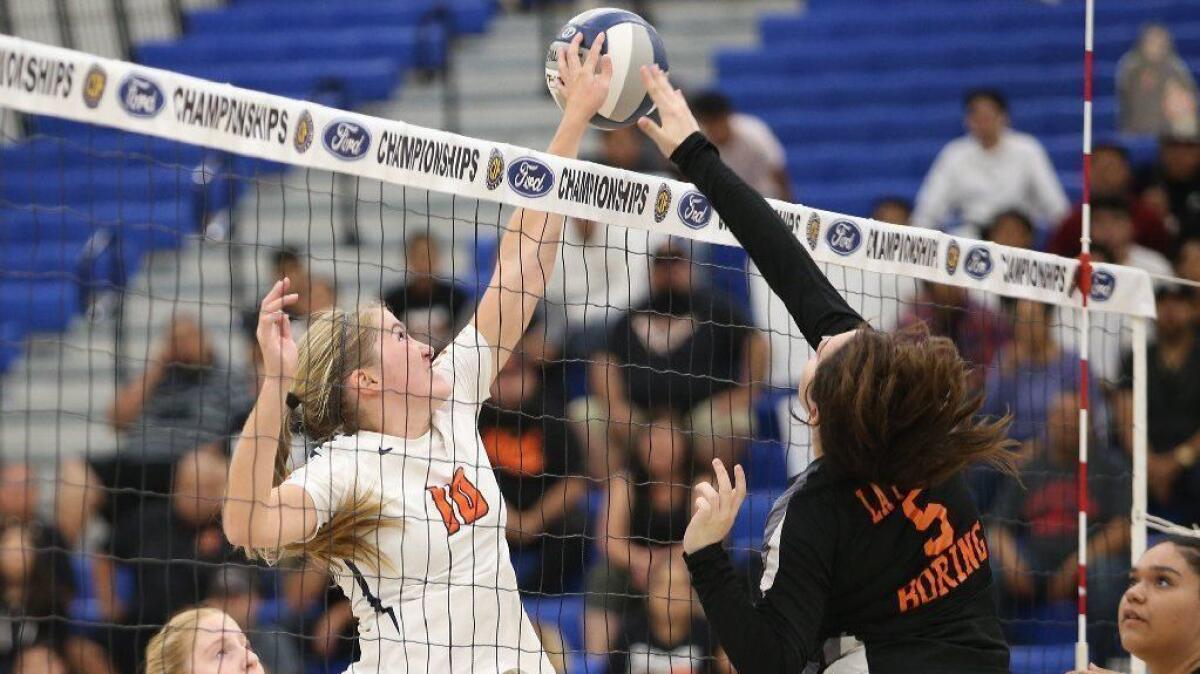 Pacifica Christian Orange County High's Allyson Scharrer, seen jousting at the net with La Puente's Kimberly Boring on Nov. 3, 2018, had 308 assists and 80 service aces in 2018.