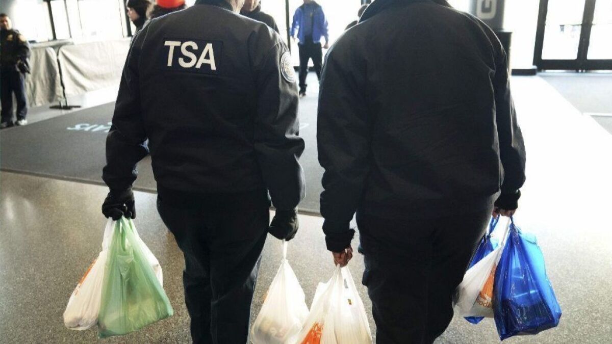 TSA workers leave an event for furloughed federal employees put on the by the Food Bank For NYC in New York on Jan. 22, 2019.