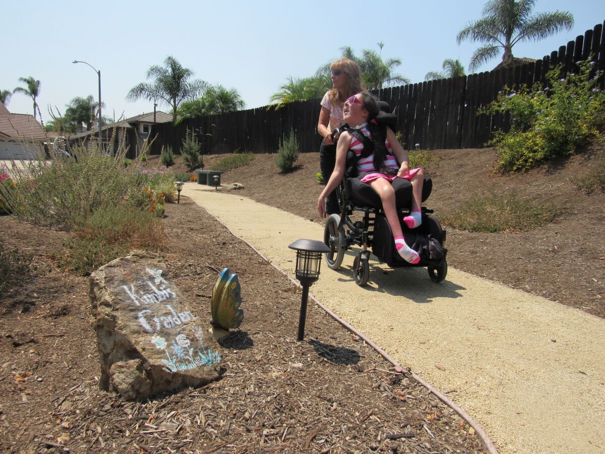 A stone with "Kimbi's Garden" on it, is for Patricia Wood's daughter, Kimberly (in wheelchair).