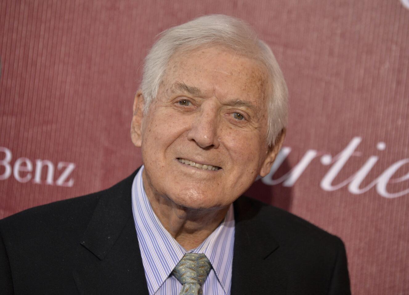 In this Jan. 4, 2014, photo, Monty Hall arrives at the Palm Springs International Film Festival Awards Gala at the Palm Springs Convention Center in Palm Springs, Calif. Former "Let's Make a Deal" host Hall died after a long illness at age 96. His daughter Sharon Hall says he died Sept. 30, 2017, at his home in Beverly Hills, Calif. Read more