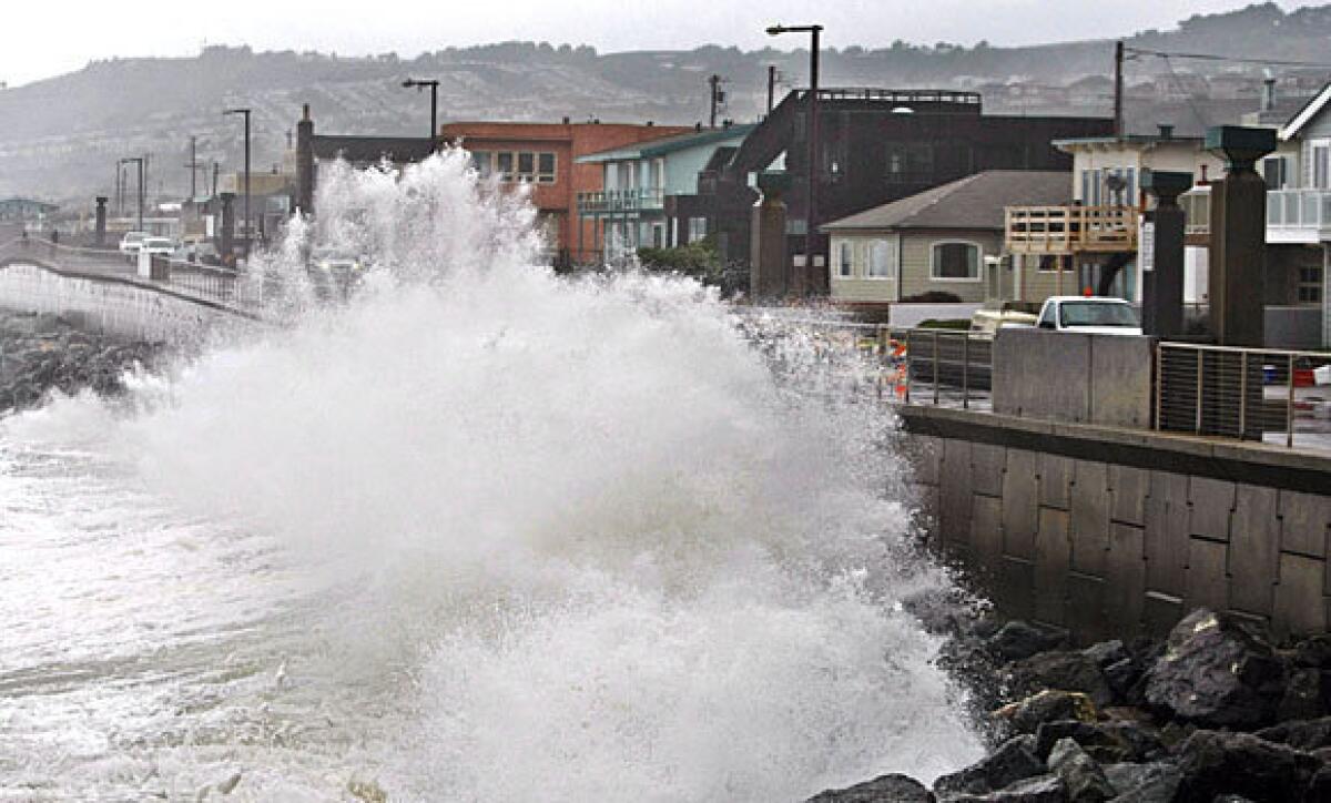 Waves pound a wall in Pacifica, Calif., during a January 2010 storm. A recent survey found that most Americans were no longer willing to accept a hands-off approach to continued coastal development that will get battered repeatedly by rising seas as the climate changes.