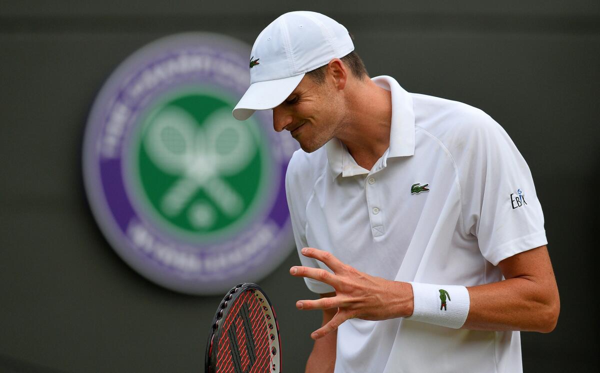 John Isner reacts after losing a point to Marin Cilic during their third-round match at Wimbledon on Friday.