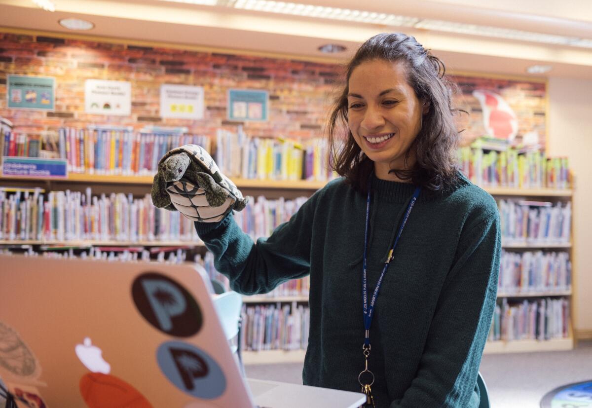 A woman puts on a virtual puppet show at a Los Angeles Public Library branch.
