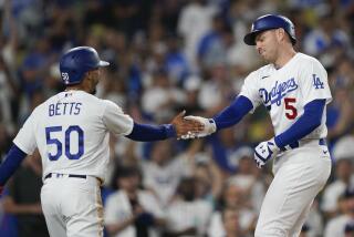 Los Angeles Dodgers' Freddie Freeman (5) celebrates his two-run home run against the Arizona Diamondbacks with Mookie Betts (50) during the third inning of a baseball game Wednesday, Aug. 30, 2023, in Los Angeles. (AP Photo/Ryan Sun)