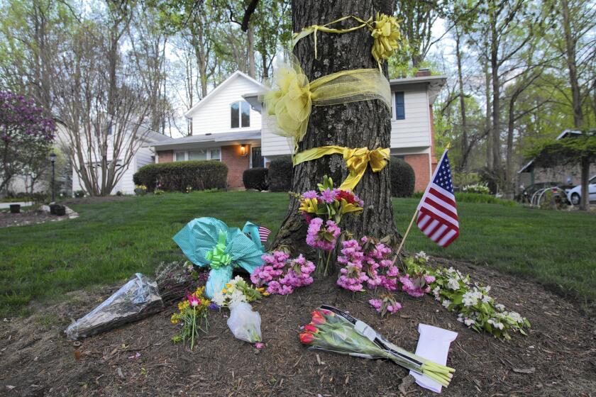 Flowers and ribbons adorn a tree outside the Weinstein family house in Rockville, Md.