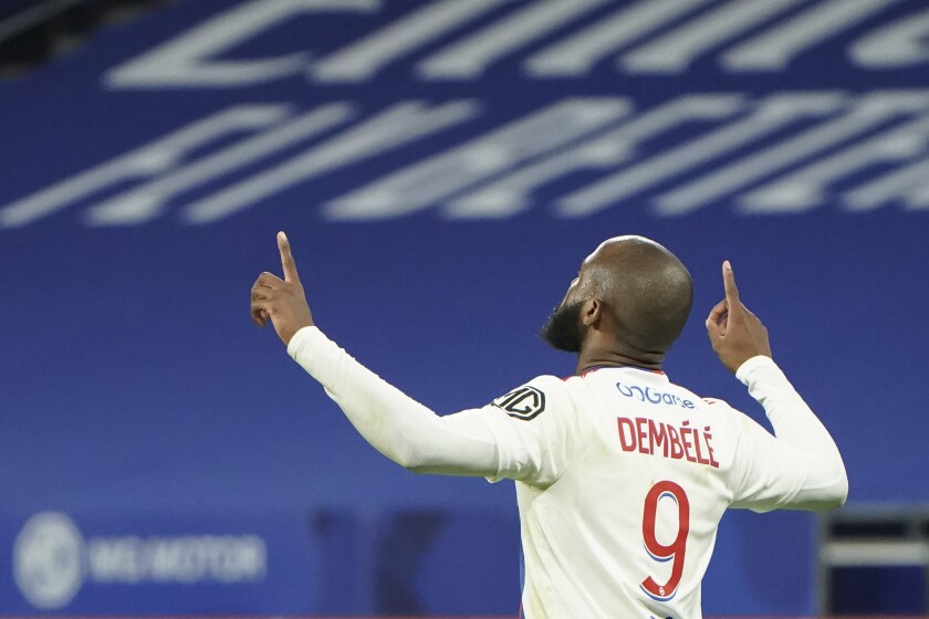 Lyon's Moussa Dembele celebrates after scores against Saint Etienne during the French League One soccer match between Lyon and Saint Etienne in Lyon, at the Groupama stadium in Lyon, France, Friday, Jan. 21, 2022. (AP Photo/Laurent Cipriani)