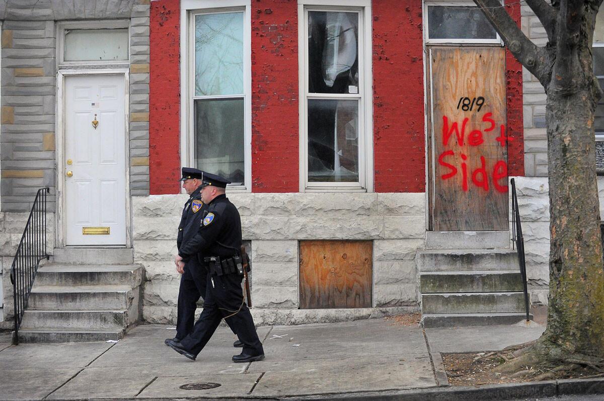 Baltimore Police Dets. Michael Boyd and Jim Mingle patrol along Walbrook Avenue in 2013.