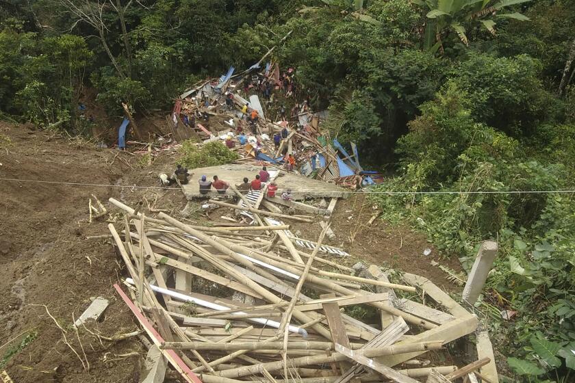 In this photo released by the Indonesian National Search and Rescue Agency (BASARNAS), rescuers search for survivors at a village hit by a landslide in Tana Toraja district of South Sulawesi province, Indonesia, Sunday, April 14, 2024. A search and rescue team found multiple people killed by landslides on Indonesia’s Sulawesi island and are still looking for a few missing, officials said Monday. (National Search and Rescue Agency via AP)