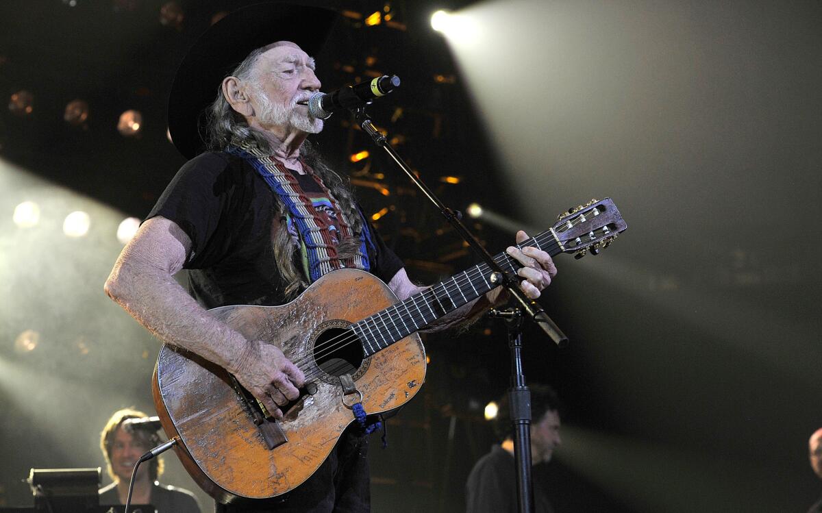 Willie Nelson performs during Keith Urban's We're All For the Hall benefit concert at Bridgestone Arena on April 16 in Nashville.