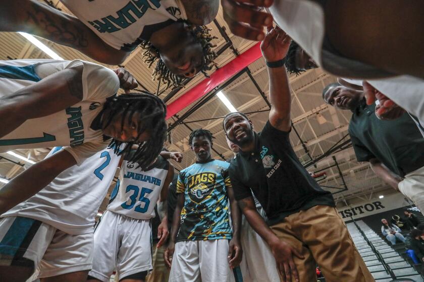 Flint, Michigan, Wednesday, March 11, 2020 - Flint coach Demarkus Jackson instructs players during a timeout at the district tournament game against Davison. (Robert Gauthier / Los Angeles Times)