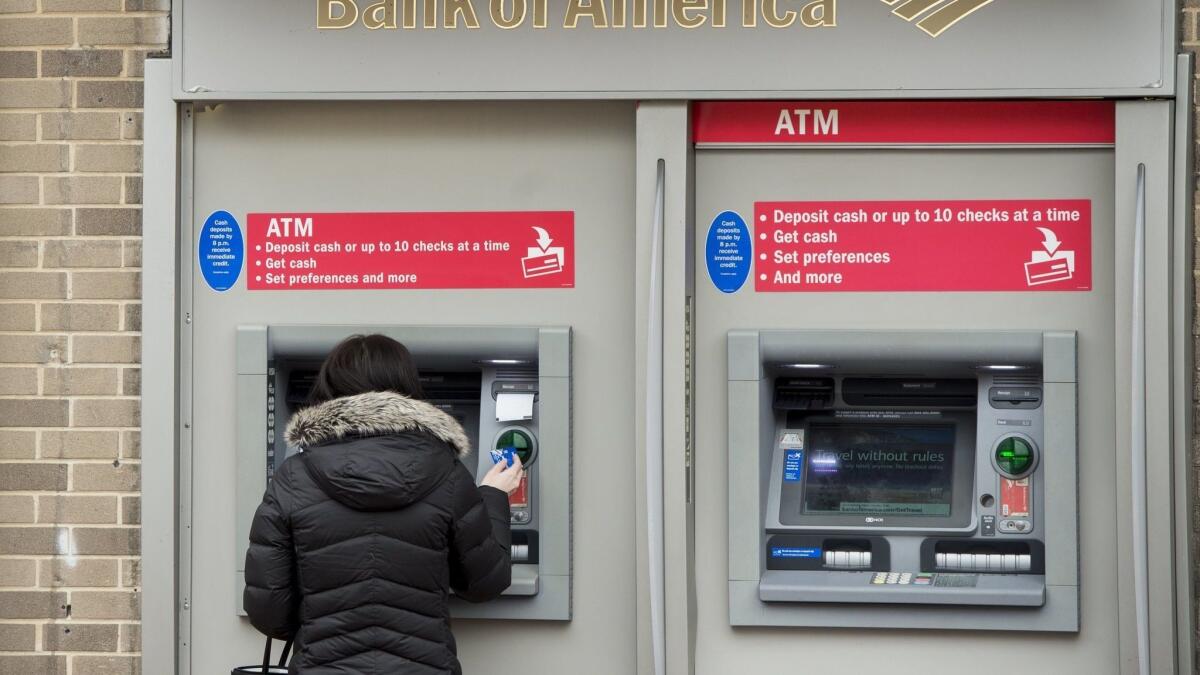 A woman using an ATM at a Bank of America branch in Washington in February 2017.